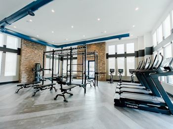 A gym with treadmills and other exercise equipment